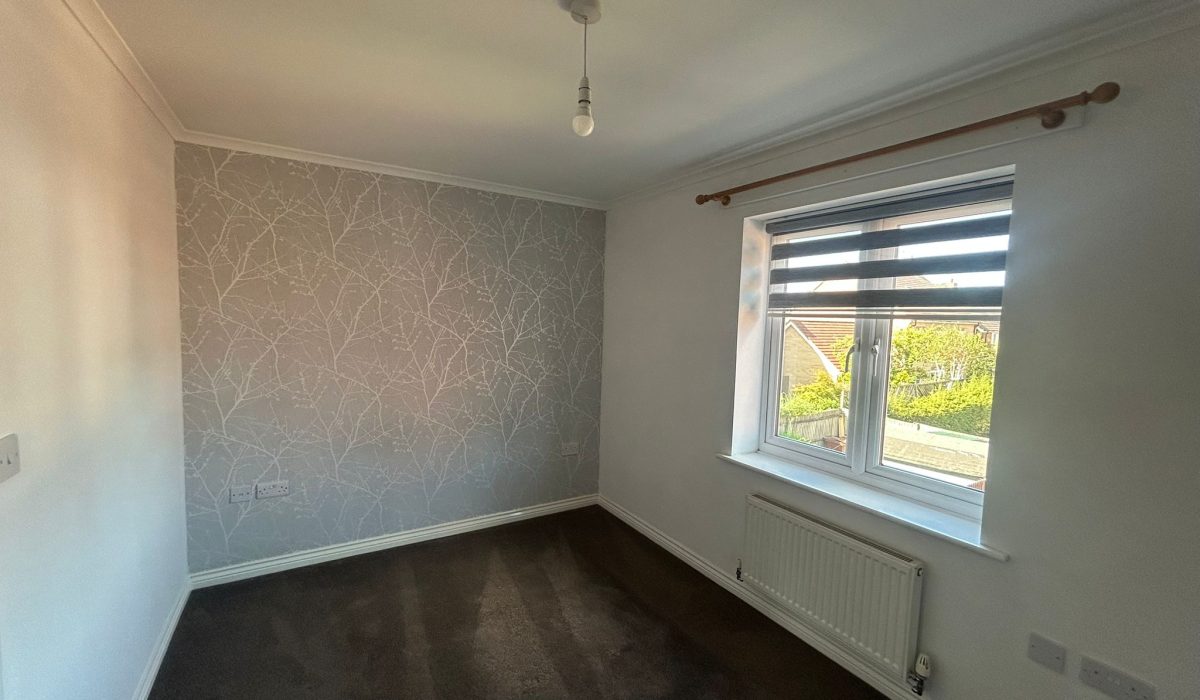 Second double bedroom with patterned feature wall and window