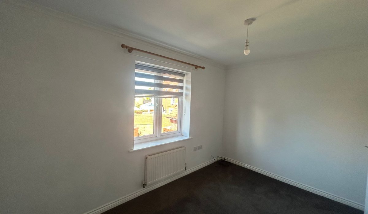 Unfurnished second double bedroom with window and radiator