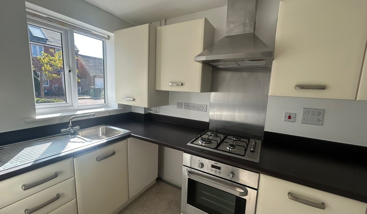Kitchen with fitted cabinets, sink, gas hob and integrated oven