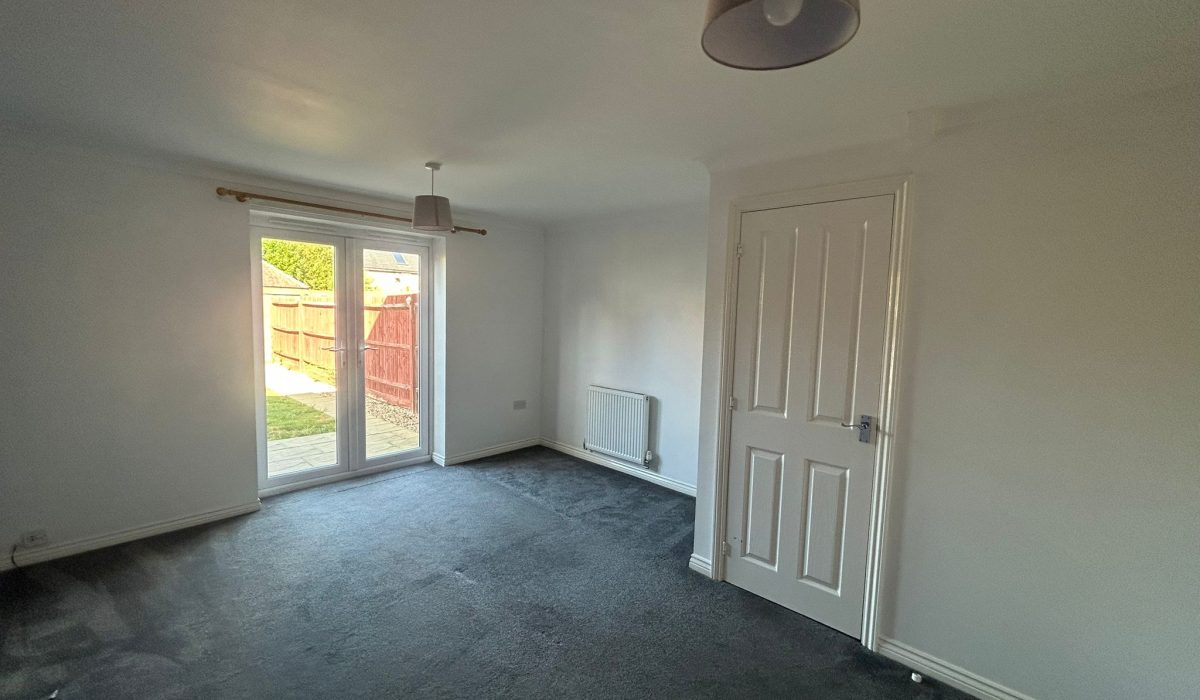 Spacious lounge and dining room with glazed doors opening onto the garden