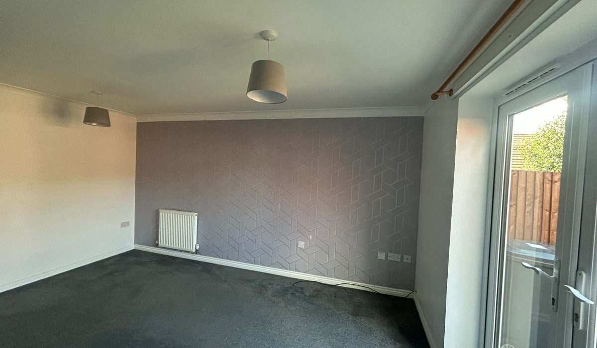 Unfurnished lounge and dining room overlooking the enclosed rear garden